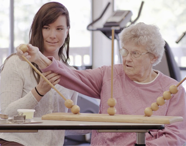 Therapist helping client with an exercise