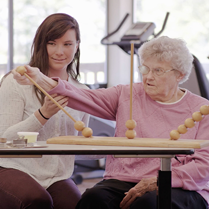 Occupational therapist assisting patient with skills exercise