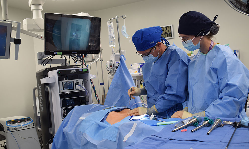 Surgeon with associate watching